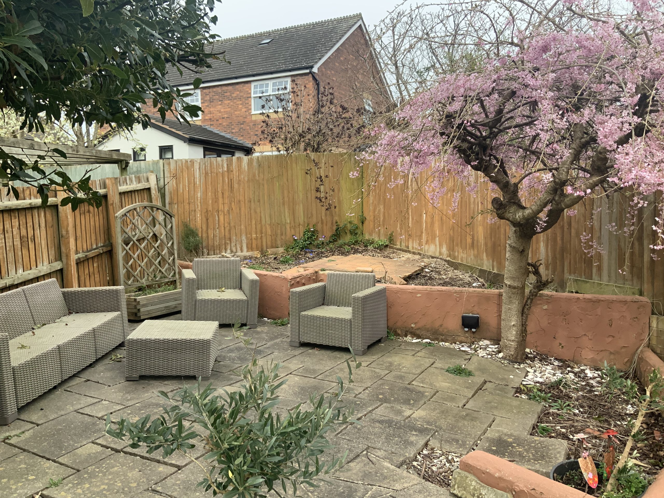 Garden in Stone with old patios and a terracotta brick retaining wall before the makeover