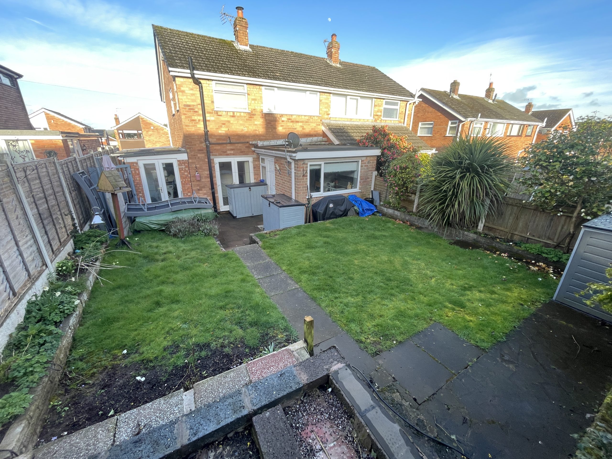Sloping garden with an old concrete shed base before the makeover, Tittensor