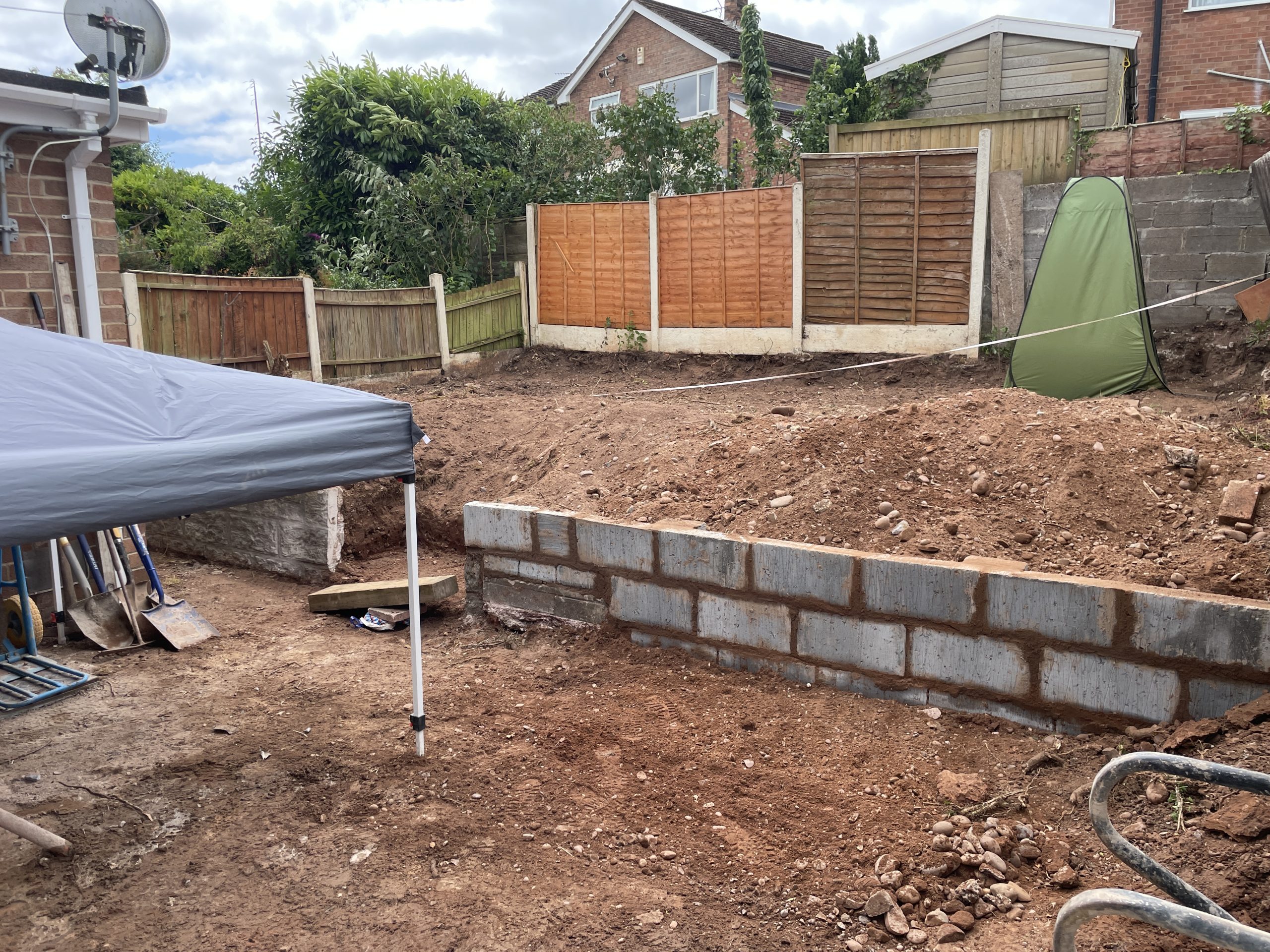 Concrete block retaining wall being built during the garden makeover, Tittensor