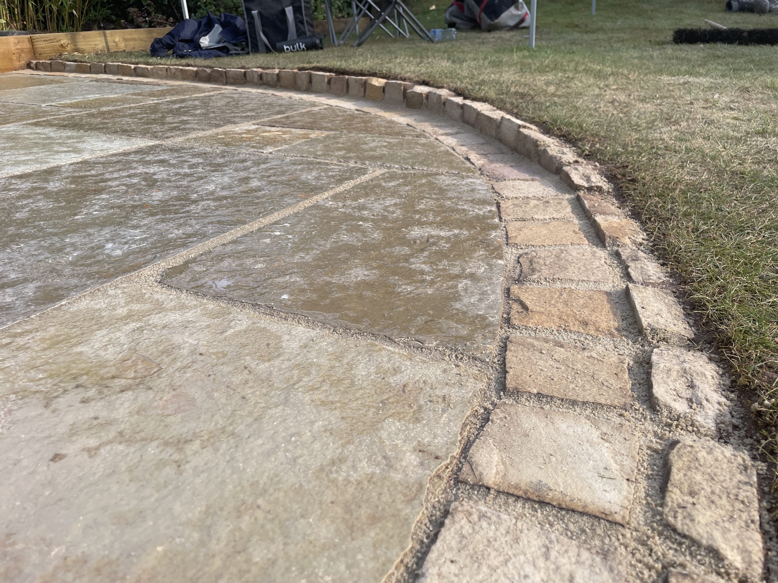 Curved natural stone patio joined seamlessly to the existing patio, Trentham