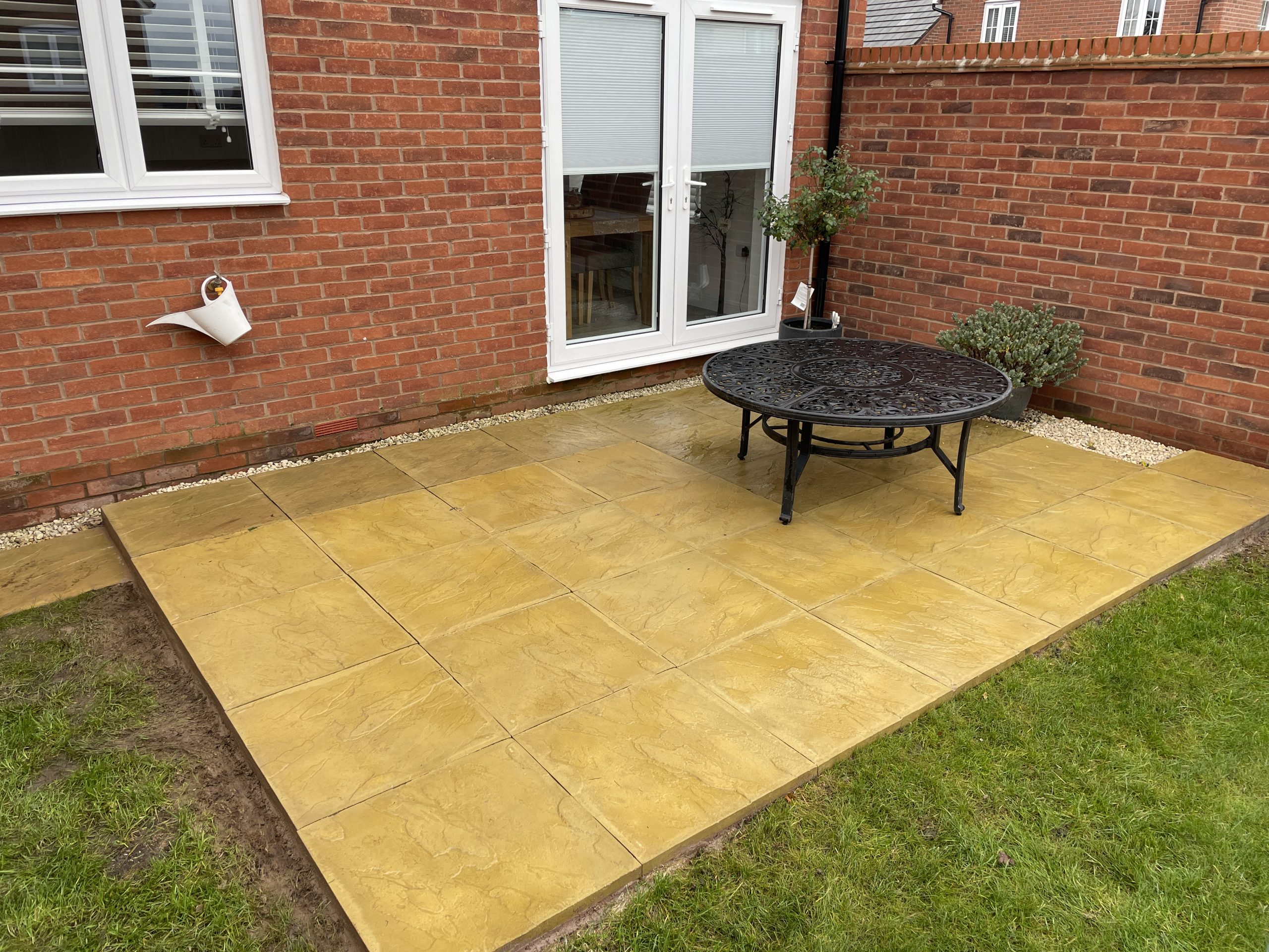 Extended rear patio with matching riven paving slabs, larger seating area, Stone, Staffordshire