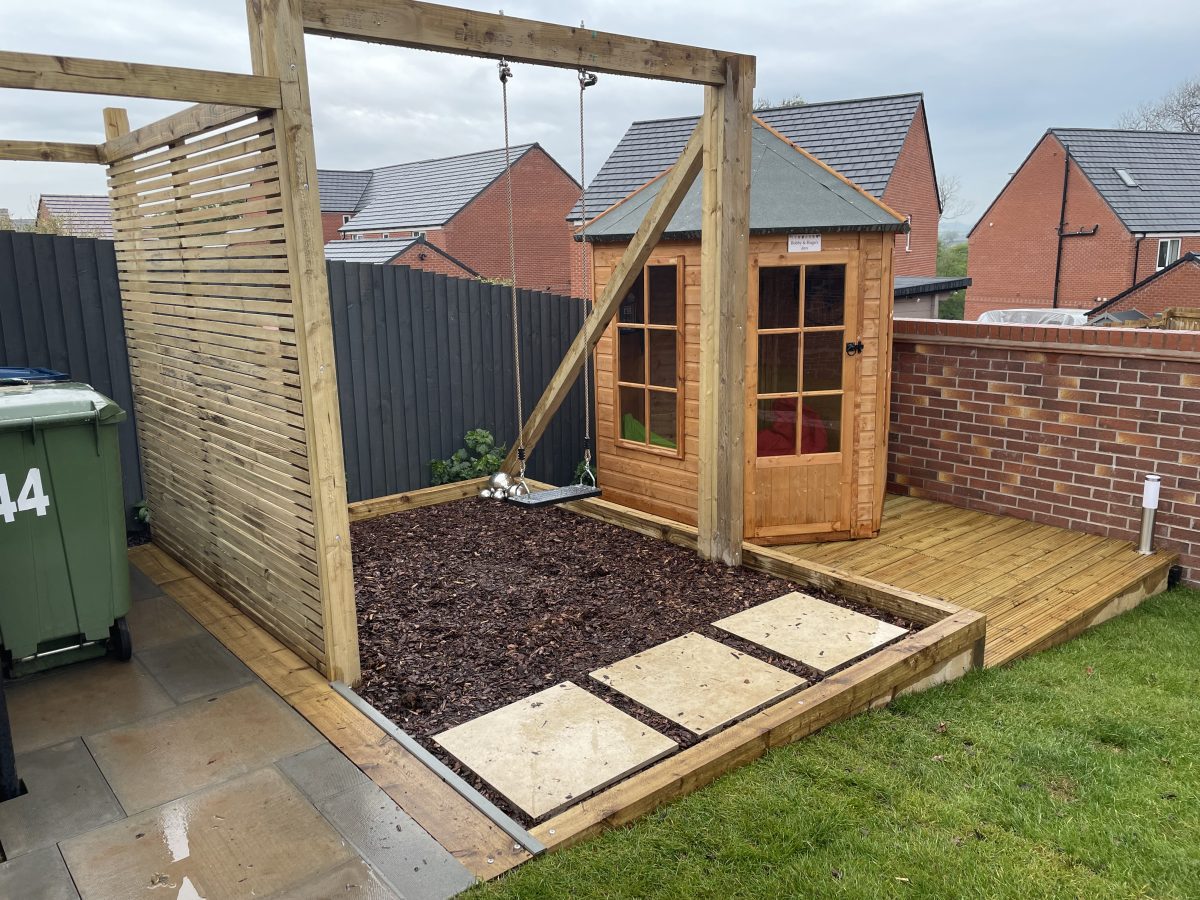Finished two-tiered timber deck platform area in a family garden, Stone, Staffordshire