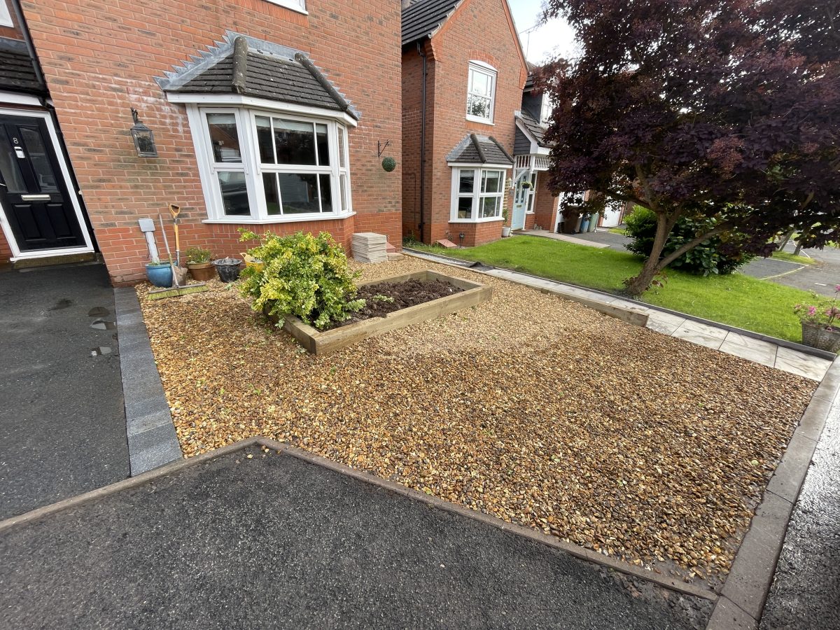 Finished front garden makeover with golden gravel, paved path and central sleeper planter, Stone, Staffordshire